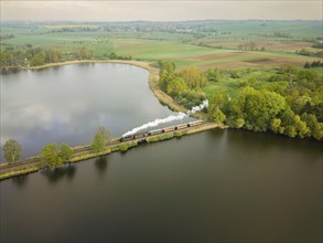 The traditional train of the Lössnitzgrundbahn runs over the dam in the Dippelsorfer pond