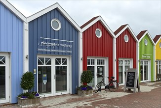 Colourful wooden houses with boutiques and restaurants, North Sea island Langeoog, East Frisian