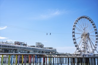 Two people on the Zip Line above the pier, The Hague, Netherlands