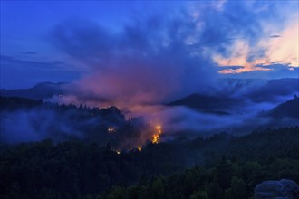 DEU Saxony Rathen Gamrig near Rathen under a full moon in the evening mist The Basteige area with