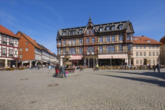 Tourists sitting outside a restaurant on the market square, half-timbered houses, Wernigerode, Harz