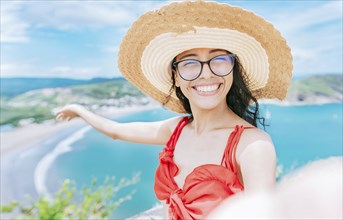 Happy tourist girl taking a selfie on the beach of San Juan del Sur. Concept of woman on vacation