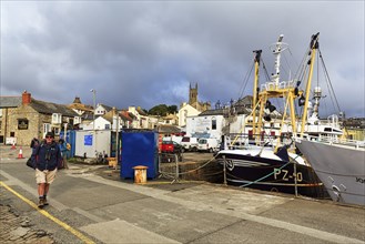 Tourists and boats in the harbour of Penzance, Cornwall, England, Great Britain