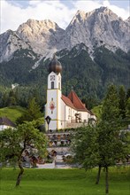 Cemetery and church of St. John the Baptist, mountain peak of the Wetterstein Mountains at the