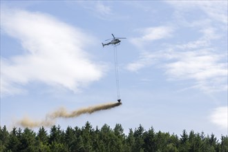 Symbolic image, climate change, helicopter, helicopter spreading finely painted limestone and wood