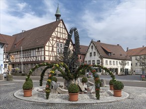 Decorated Easter fountain, town hall in the back, Waldenburg, Baden-Württemberg, Germany, Europe