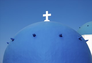 Close-up of blue dome with white cross, Agios Spiridonas, St Spyridon Church, Ia, Oia, Santorini,