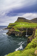 Gasadalur waterfall into the ocean, Vagar, Faroe islands, Denmark, Europe