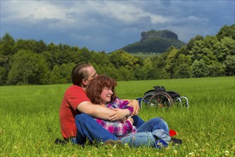 Young couple on the meadows in front of Königstein Fortress