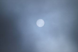 Moon shining through clouds at evening, Bavaria, Germany, Europe