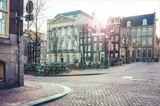 View of an Amsterdam street with typical houses and full of bikes