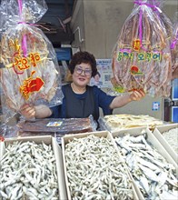 Korean market woman with dried squid, Yeosu fish market, Yeosu, Jeollanam-do province, South Korea,