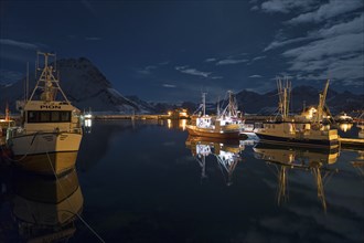 Water reflection in Ramberg harbour on New Year's Eve, Lofoten, Norway, Europe