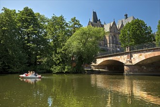 Pedal boat on the river Lahn with the Old University and the Weidenhäuser Bridge, Marburg, Hesse,