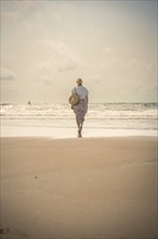 Woman on the beach in the evening sun, Zandvoort, Netherlands