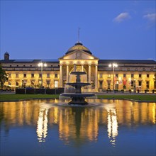 Illuminated spa hotel and Casino in the evening with cascade fountain, Wiesbaden, Hesse, Germany,