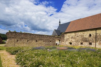 DEU Saxony Klosterbuch Area of the former cloister with Romanesque fountain bowl in the Kreugarten