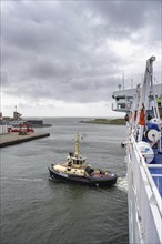 Tug, towing assistance, EDDY Tug towing the ferry King Seaways out of the harbour of Ijmuiden,