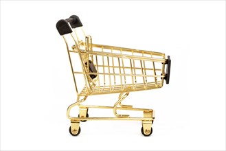 Empty golden shopping cart isolated on white background