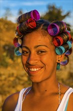 Local woman with curling irons is laughing. Fogo. Cabo Verde. Africa