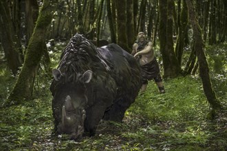 Diorama showing Neanderthal hunter chasing woolly rhinoceros (Coelodonta antiquitatis) at Prehisto