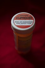 A label on a bottle of hydrocodone-acetamin opioid prescription pills warns against the danger of