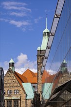 View through Bretgasse to the town hall with the reflection in Galeria Kaufhof