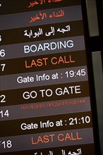 Last call, check-in, departure board with departure schedule in different languages, gates at