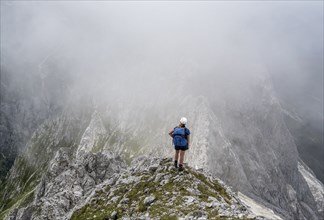 Mountaineer in fog, bad weather, Wetterstein Mountains, Garmisch-Patenkirchen, Bavaria, Germany,