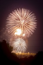 Closing fireworks of the Bergstadtfest at the Reiche Zeche above the towers of Freiberg