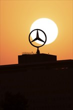 Mercedes star on Mercedes Benz branch in Stuttgart, sunset, Baden-Württemberg, Germany, Europe