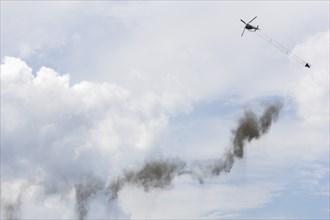 Symbolic image, climate change, helicopter, helicopter spreading finely painted limestone and ash