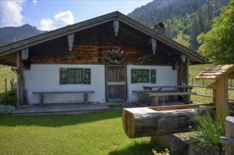 Detailed view of an idyllic alpine hut with well on the Rötelmoosalm, Chiemgau, Bavaria, Germany,