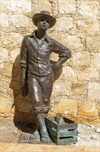 Bronze sculpture statue of a fisherman by city wall Campeche, Campeche State, Mexico, Central