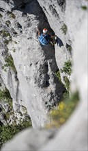 Climber on the rope, multi-pitch climbing, Via la Bellezza della Venere climbing tour, Garda