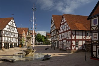 Market square with market fountain and maypole in the historic old town with many half-timbered