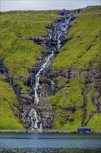 Waterfall tumbling down the hill, Streymoy, Faroe islands, Denmark, Europe