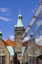 View through Bretgasse to the town hall with the reflection in Galeria Kaufhof