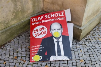 Election poster of Olaf Scholz SPD, lying torn down in Potsdam city centre