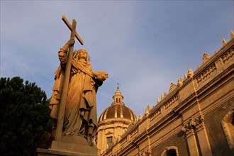 Super wide angle shot, sculpture, Fortes in Fide, with cross, evening light, Cathedral, Catania,