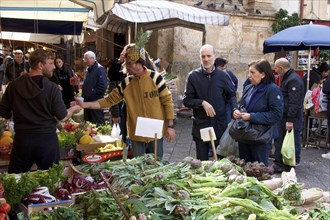 Vegetable and fruit stall, customers, vendor with pineapple as hat, markets, open air, Palermo,