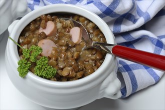 Lentil (Lens culinaris) dish with sausage slices in a bowl, lentil