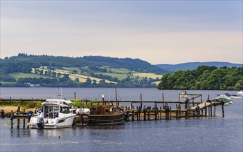 Boats in Balmaha at sunset, Loch Lamond, Scotland, UK