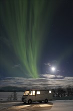 Motorhome by Lake Kilpisjärvi and Northern Lights (Aurora borealis) in Winter Landscape, Enontekiö,