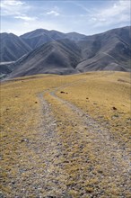 View over eroded mountainous landscape with brown hills, mountains and steppe, Chuy province,