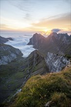 View over Säntis mountains into the valley of Meglisalp at sunrise, high fog in the valley, Säntis,