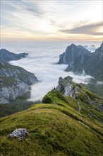 View over Säntis mountains into the valley of Meglisalp at sunrise, Rotsteinpass, high fog in the