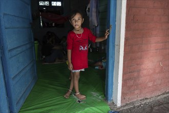 Meitei community man stays in a makeshift shelter after a mob burn their houses during an ethnic