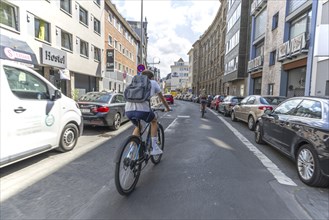 Cycling from a first-person perspective on a street in Cologne, North Rhine-Westphalia, Germany,