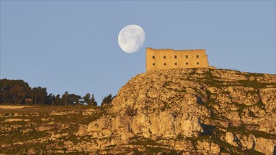 Morning light, super clear blue sky, huge full moon, fortress-like building on the mountain, Erice,